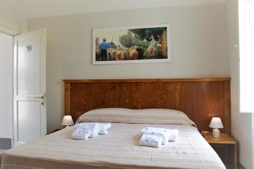 a bedroom with a bed with white pillows on it at Dimora Li Cuti in Sannicola