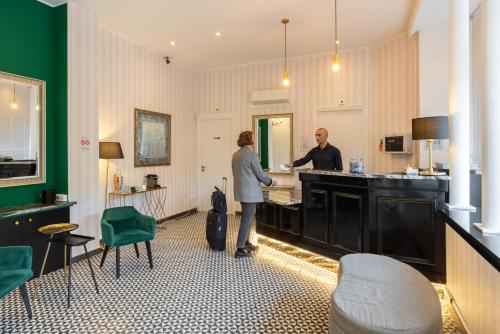 a man and a woman standing in a kitchen at Hotel Aria in Nice