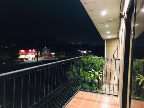 a balcony with a view of a city at night at Loma Alta Home in Santa Ana