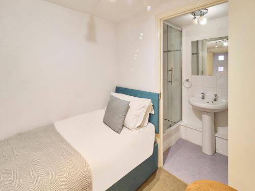a small bedroom with a bed and a sink at Host & Stay - Queen's Corner in Canterbury