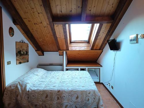 una piccola camera con letto e finestra di Chiara Loft a Stresa