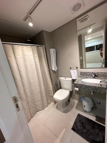 a bathroom with a toilet and a sink and a shower at Edificio Tiana- Los Laureles (Asuncion) in Asuncion