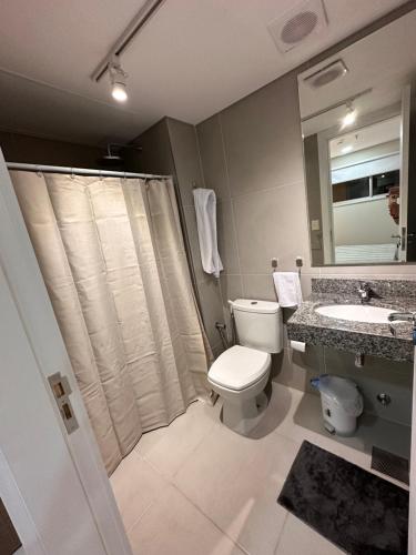 a bathroom with a toilet and a sink and a shower at Edificio Tiana- Los Laureles (Asuncion) in Asunción