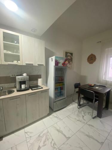 a kitchen with a refrigerator and a table in it at Vila Safir in Loznica