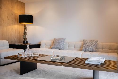 a living room with a couch and a coffee table at EcrinBlanc - Appartement Haut de Gamme - Balcon avec vue - Centre de Megève in Megève