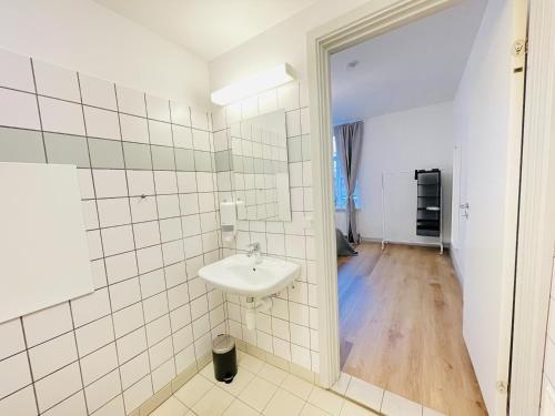 a bathroom with a sink and a mirror at aday - The Swanky Suite in Hjørring