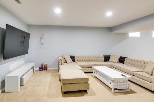 a living room with a couch and a table at Pet-Friendly Lanham Getaway with Community Pool! in Lanham