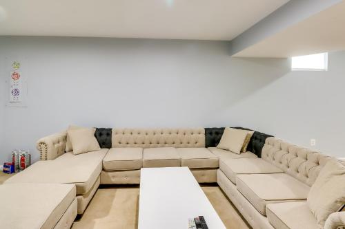 a living room with a couch and a table at Pet-Friendly Lanham Getaway with Community Pool! in Lanham