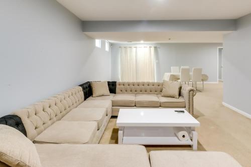 a living room with a couch and a table at Pet-Friendly Lanham Getaway with Community Pool! in Lanham