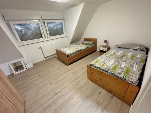 two twin beds in a room with two windows at B&B Immobilien GbR in Xanten