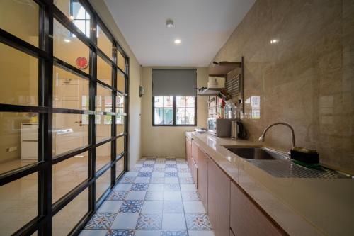 a large kitchen with a sink and a window at Danka@tudor residence in Batam Center