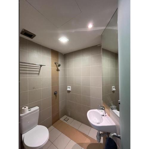 a bathroom with a toilet and a sink at Sakura Elite Kuala Lumpur in Kuala Lumpur