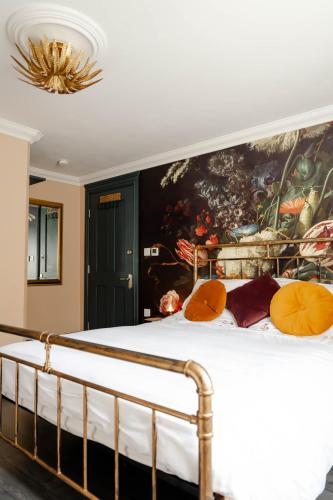 a bedroom with a bed with a painting on the wall at Anne Boleyn’s Escape in Deal