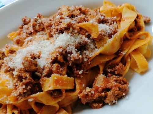 a plate of pasta with meat and cheese at Casale IL SAMBUCO sui colli bolognesi in San Lazzaro di Savena