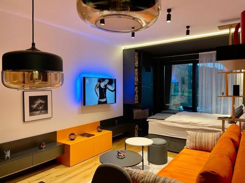 a living room with a couch and a bed at NA STAZI-Luxury Mountain- on the ski slope-Free parking,Tuzlaks apartment in Bjelašnica