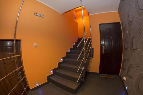 a staircase in a building with a black door at Apartamenty Pilsko in Korbielów