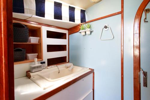 uma casa de banho com um lavatório e um chuveiro em Evamia Boat em Lisboa