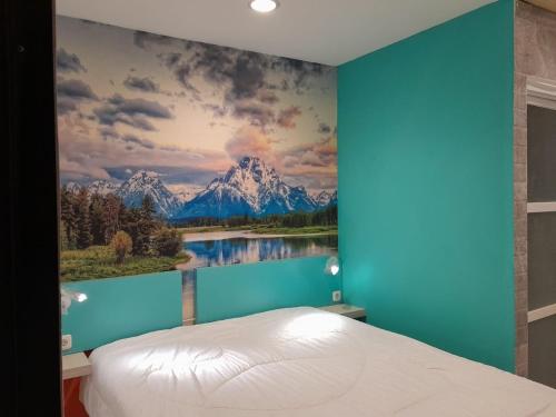 a bedroom with a mountain mural on the wall at Cozy centre Simpang Lima Semarang in Semarang