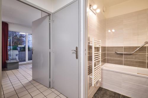 a bathroom with a shower and a tub and a sink at Bulle enchantée lac et montagne in Allevard