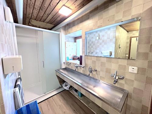 a bathroom with a sink and a mirror at Jugendherberge Hospental in Hospental