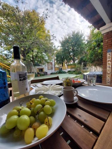 a plate of grapes on a table with a bottle of wine at N1 Casa de Madrid - greenpeace line in Madrid