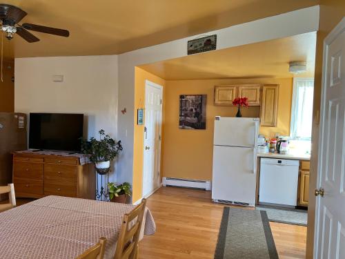 a kitchen with a white refrigerator and a table at Beautiful 2-Bedroom, 2-Bath Townhouse in Boston