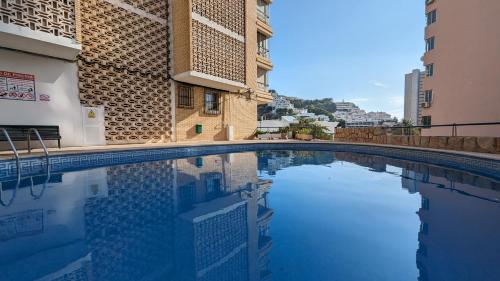 a swimming pool in front of a building at GALEON sea view apartment in Benidorm