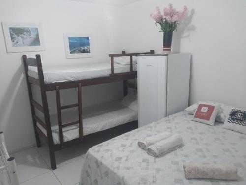 a small bedroom with a bunk bed and a desk at Flat Beach Itamaracá - pousada FBI in Itamaracá