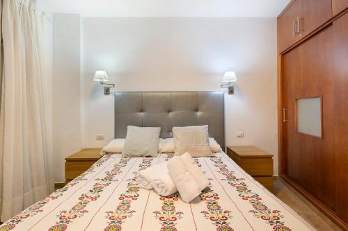 a bedroom with a large bed with two pillows at Beautiful Arenas Negras By Paramount Holidays in Puerto de Santiago