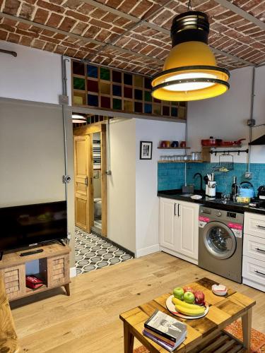 a kitchen with a table with a plate of fruit on it at Heristage Istanbul Galataport in Istanbul