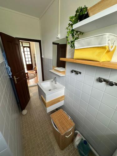 a bathroom with a sink and a toilet at Villa Flora, escapade champêtre in Petit-Canal