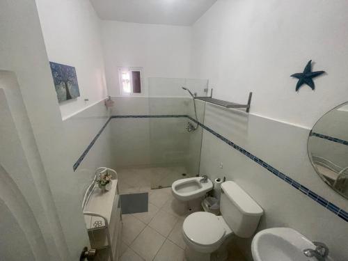 a bathroom with two toilets and a sink at B&B Villa Luna in Bayahibe