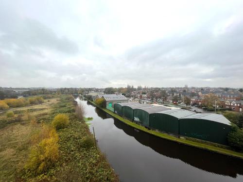 a train traveling down a river next to a body of water at Plush Apartment 2 bed for Business and Pleasure in Wakefield