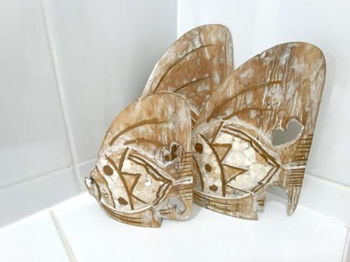 a wooden butterfly wall decoration in a bathroom at Karingal in Nambucca Heads