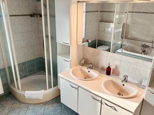 łazienka z 2 umywalkami i prysznicem w obiekcie Taos B&B w mieście Vresse-sur-Semois