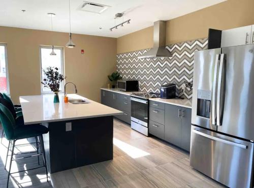 a kitchen with a stainless steel refrigerator and a counter at New Modern 1 BR in Heart of Midtown in Kansas City