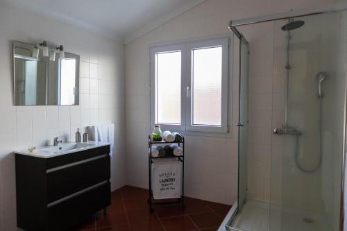 a bathroom with a sink and a shower at By the hill in Ribeira Grande