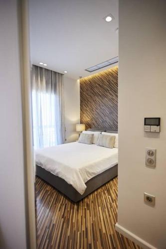 a bedroom with a bed and a large window at A3_Aplotaria Architect's Apartment in Chios