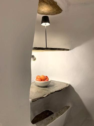 a bowl of oranges on a table in a room at PANO Apartment in Triandáros