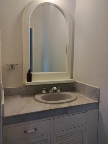 a bathroom with a sink and a mirror at Casa Tzunun Airport Junior Suite in Cancún