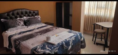 a bedroom with a bed with a tray on it at HOSTAL LLAUT * * in Moquegua