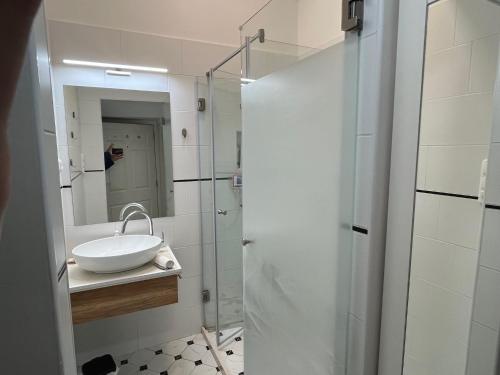a bathroom with a sink and a glass shower at Studio flat in the center of Budapest in Budapest