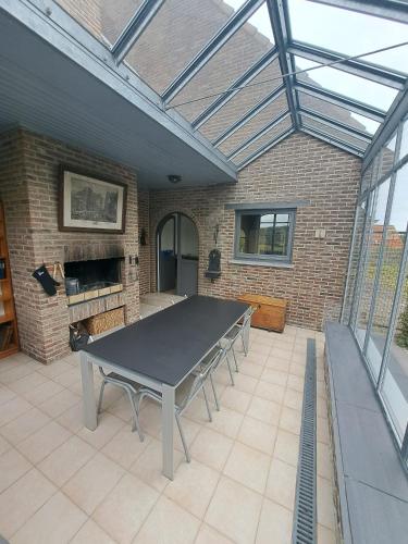 a ping pong table in a patio with a brick wall at Villa SandNest in Koksijde