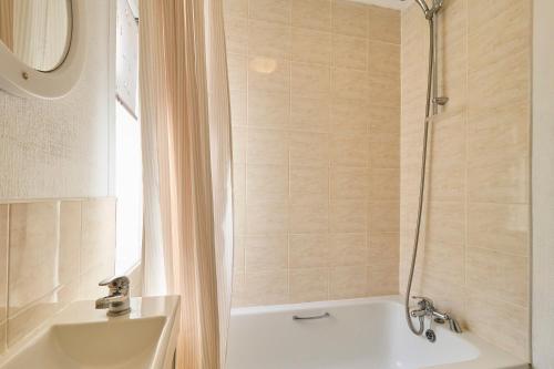 a bathroom with a tub and a shower and a sink at Host & Stay - Westbrook Road in Margate