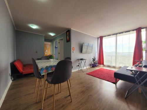 ein Wohnzimmer mit einem Tisch und Stühlen im Zimmer in der Unterkunft ChileRuca Departamentos Amoblados in Santiago