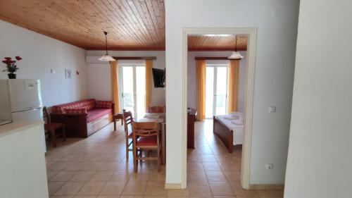 a kitchen and a living room with a couch and a table at Captain's House in Sivota