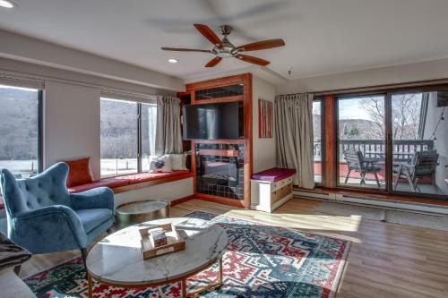 a living room with a couch and a ceiling fan at Mountain Green Condo 3F1 condo in Killington