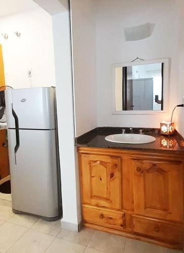 a kitchen with a refrigerator and a sink at Belgrano 238 in Capilla del Monte