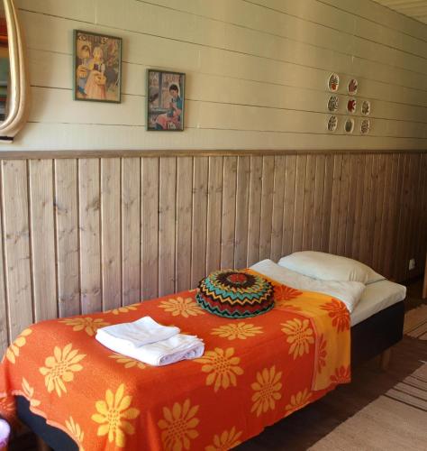 a bed in a room with avertisement at Suopirtti bed & breakfast and sauna in Konnevesi