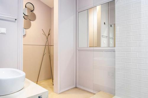 a white bathroom with a shower and a sink at Boutique house with Pateo in Sintra